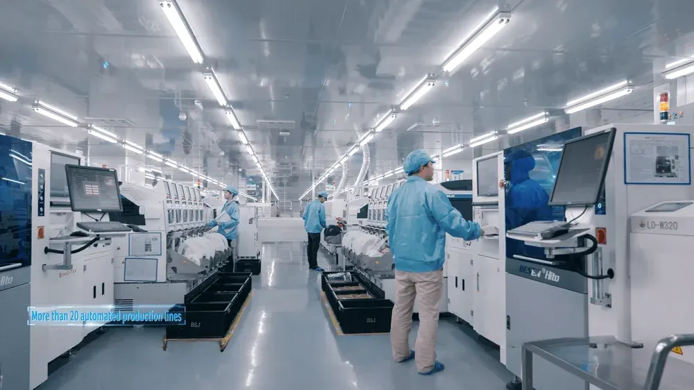 A BSJ surface-mount line: operators in cleanroom coats between feeder banks.